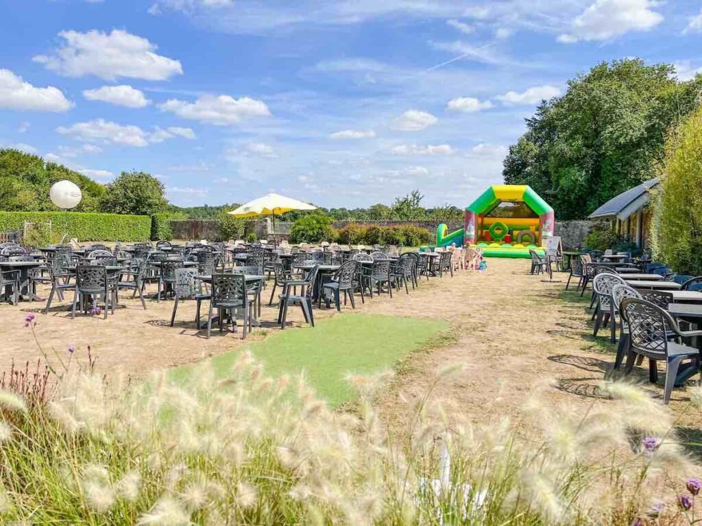 La-Garangeoire beer garden area, with grass, chairs and a bouncy castle