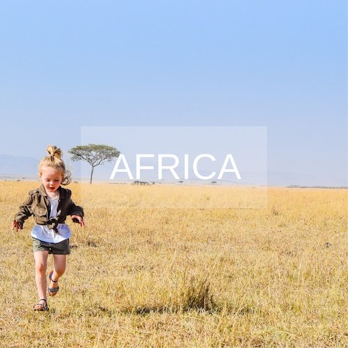 Young girl runs across the golden plains of the Masai Mara on safari