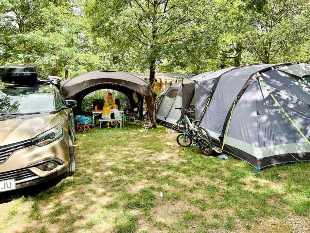 Large 10-man tent set up with gazebo at Camping la Grande Tortue