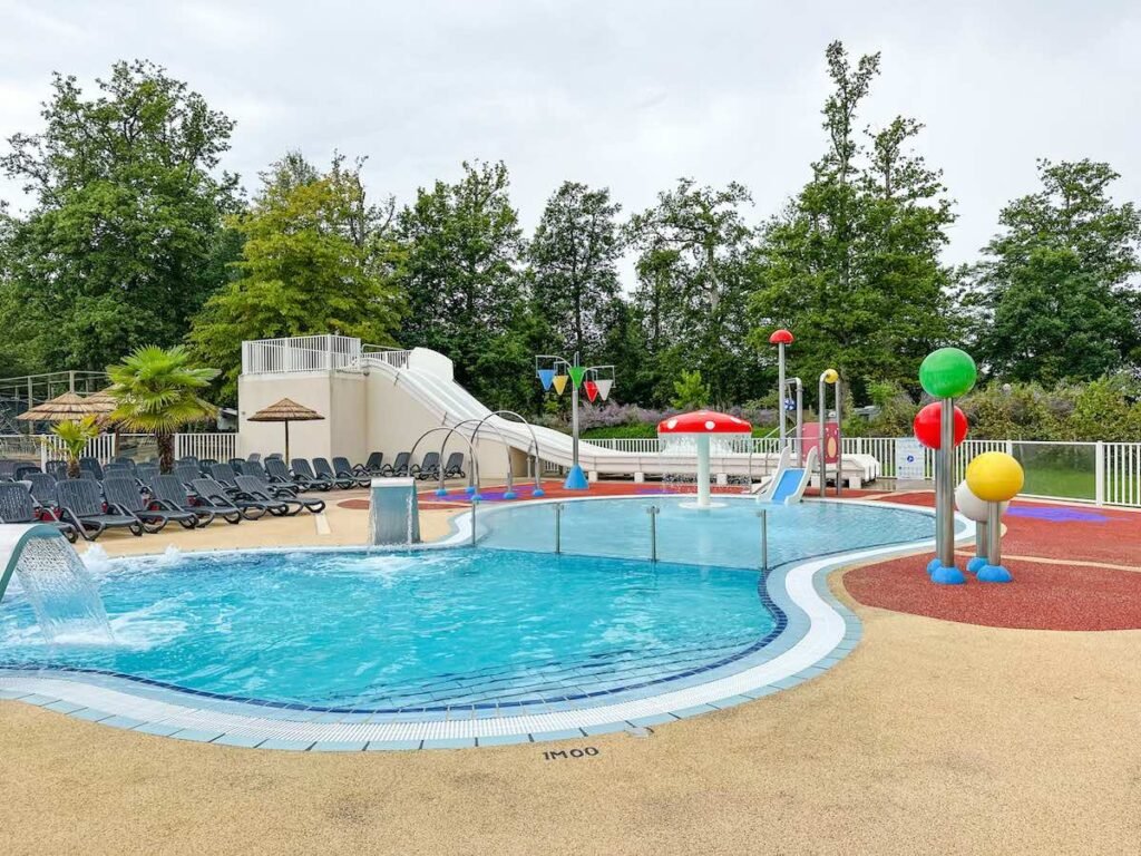 Swimming pool complex at Camping la Grande Tortue, with colourful fountains and slides