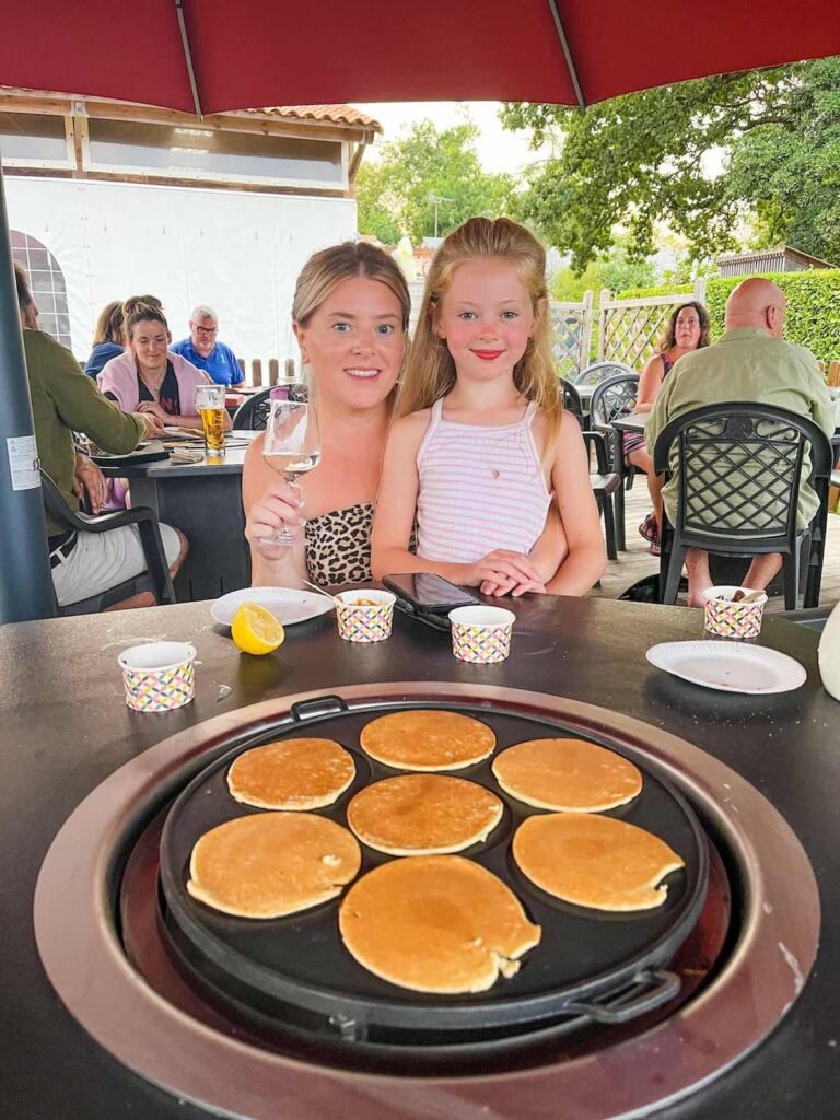 Mother and daughter enjoy the crepe party at  Castel Camping La Garangeoire