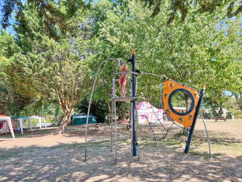 Girl plays on climbing frame at La Garangeoire play area