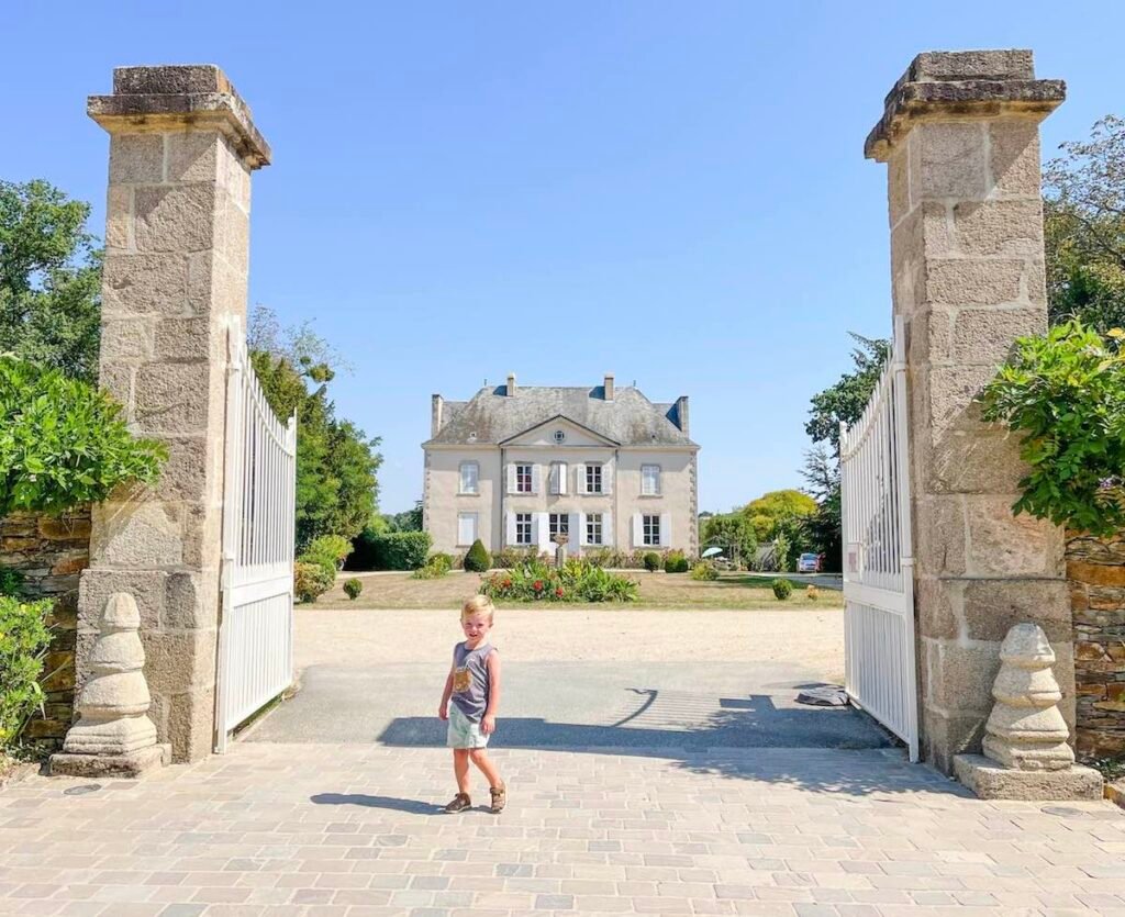 Young boy stands in the gateway to the Château at La Garangeoire