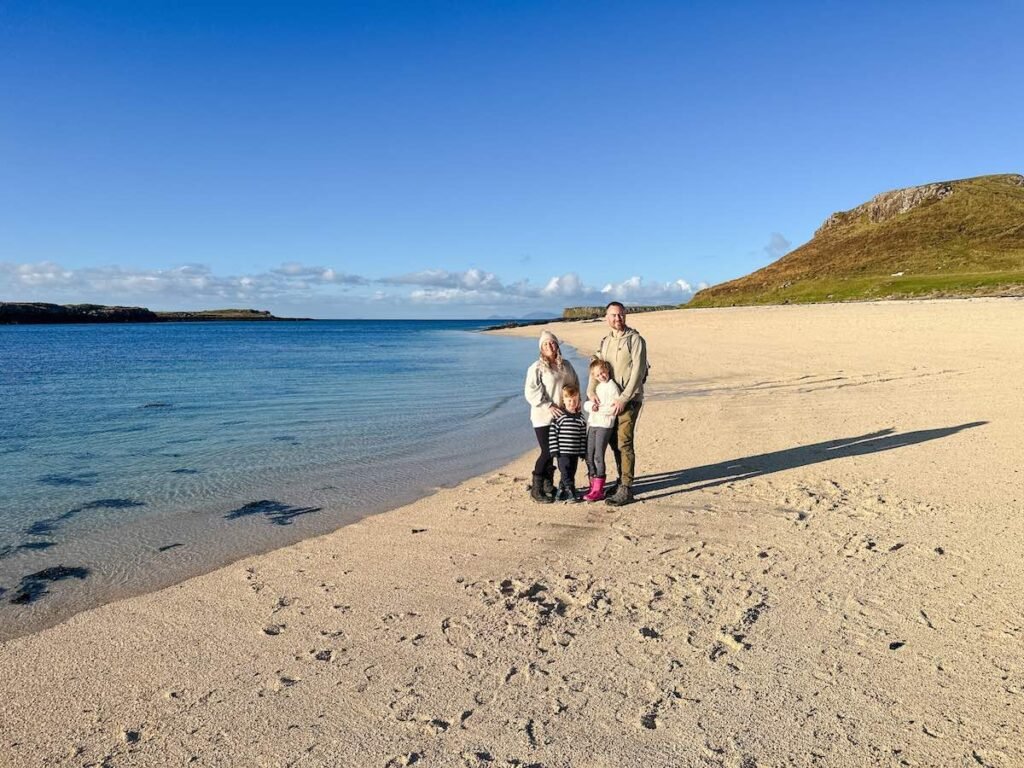 Family standing on Coral Beach on the Isle of Skye