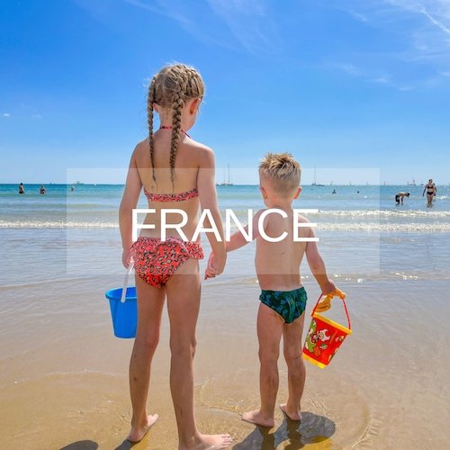 Siblings stand on the beach in Vendee