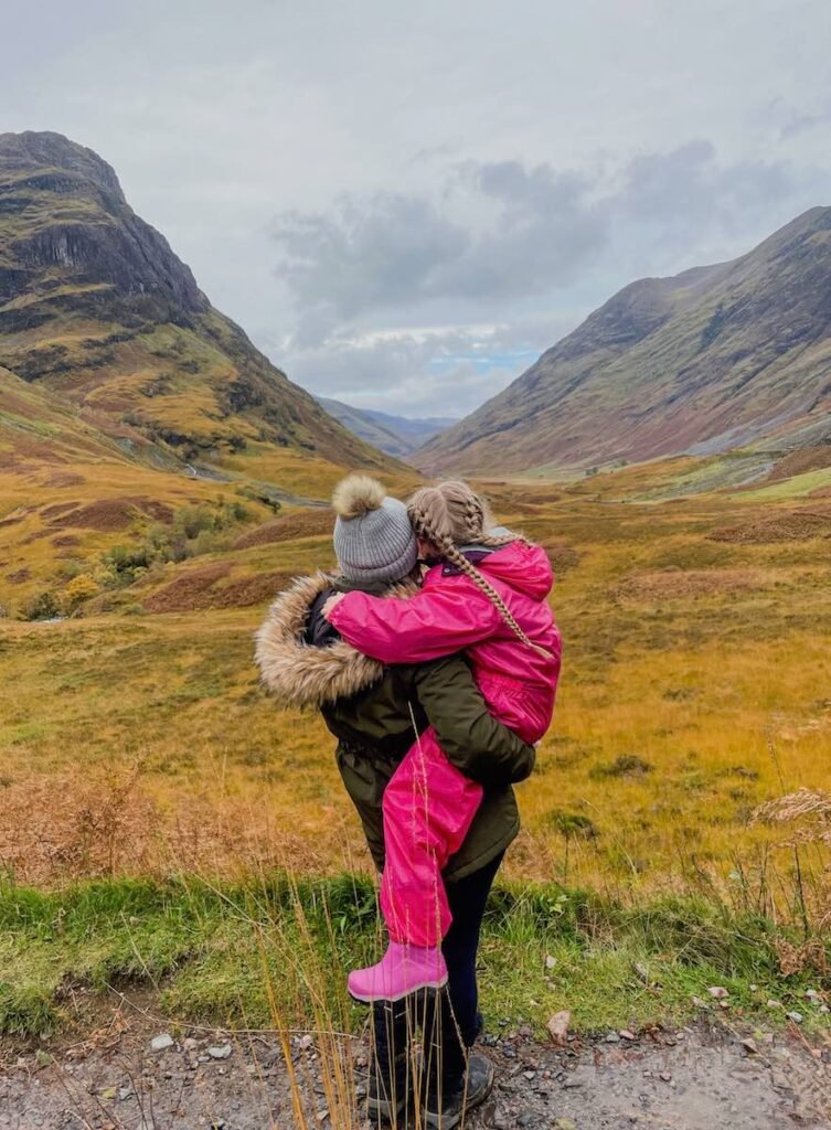 Mother and daughter look out over 
Glen Coe Three Sisters