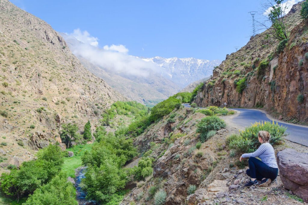 Woman sits overlooking the High Atlas Mountains in Morocco