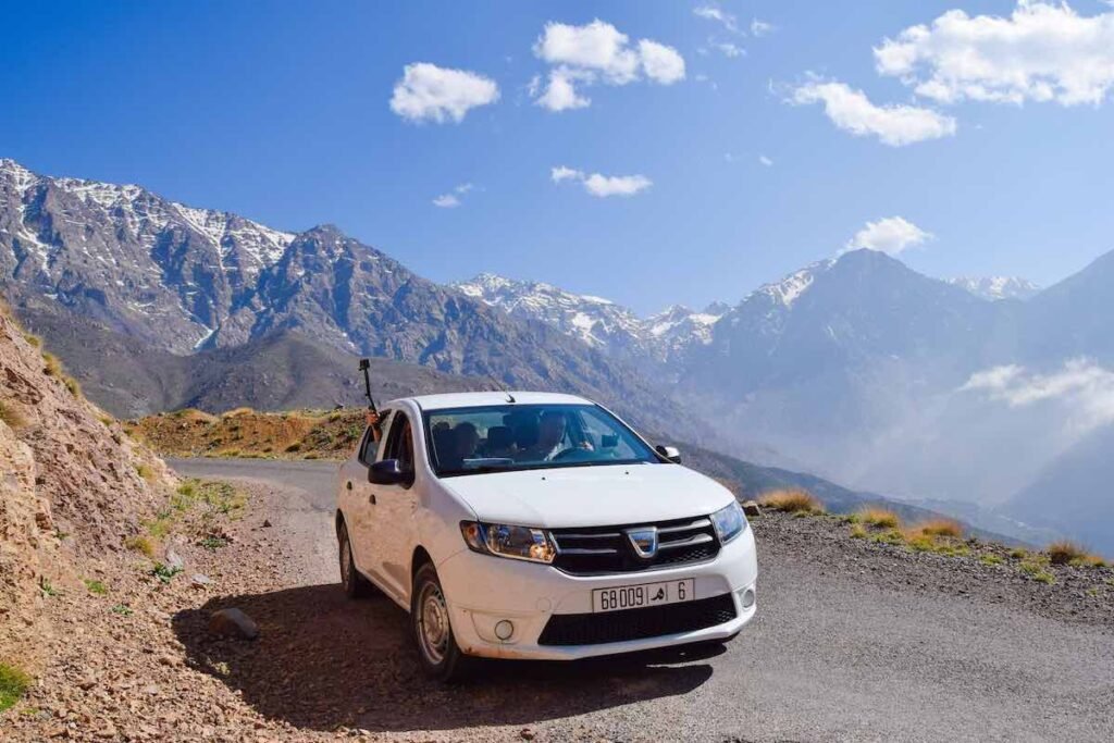 White car driving along a road in the High Atlas Mountains in Morocco