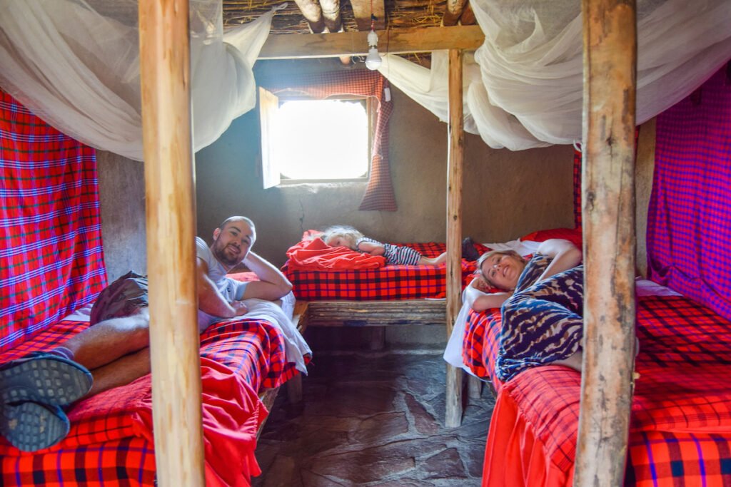 Family enjoy relaxing at Maji Moto Maasai Cultural Camp in their Maasai manyatta hut