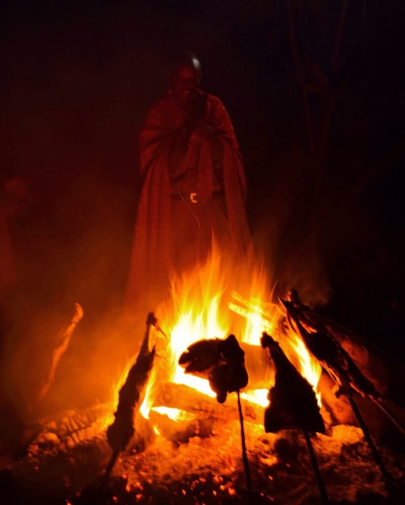 Maasai Warrior stand by the camp fire at Maji Moto Maasai Cultural Camp