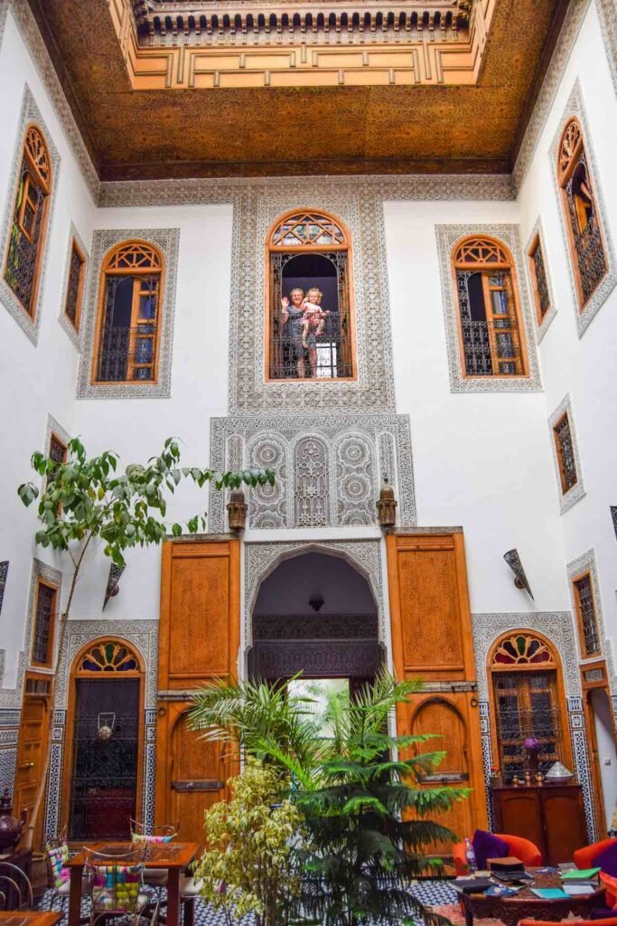 Beautiful interior at Riad La Cle De Fes, with plants, stained glass and Moroccan tiles