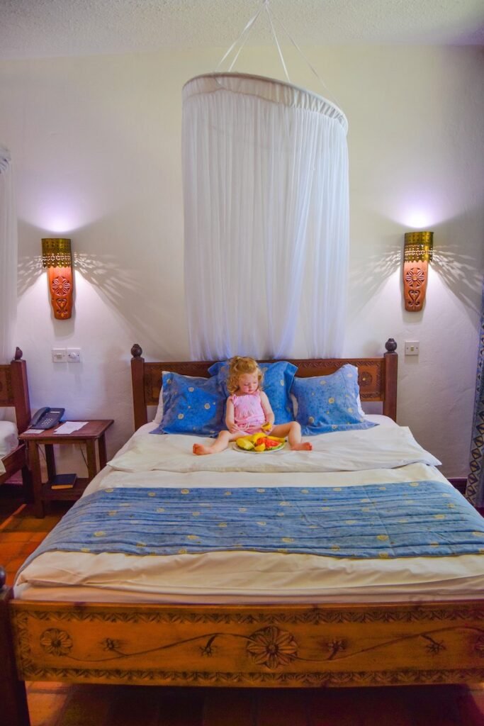 Double bedroom with white walls and a hanging net over the bed, at Severin Sea Lodge