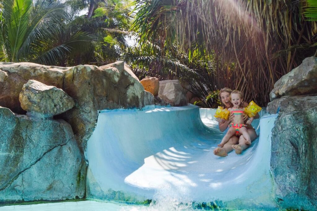 Mother and child going down a blue water slide at Sever Sea Lodge