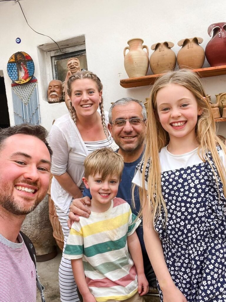 Family stand in Avanos pottery shop Cappadocia