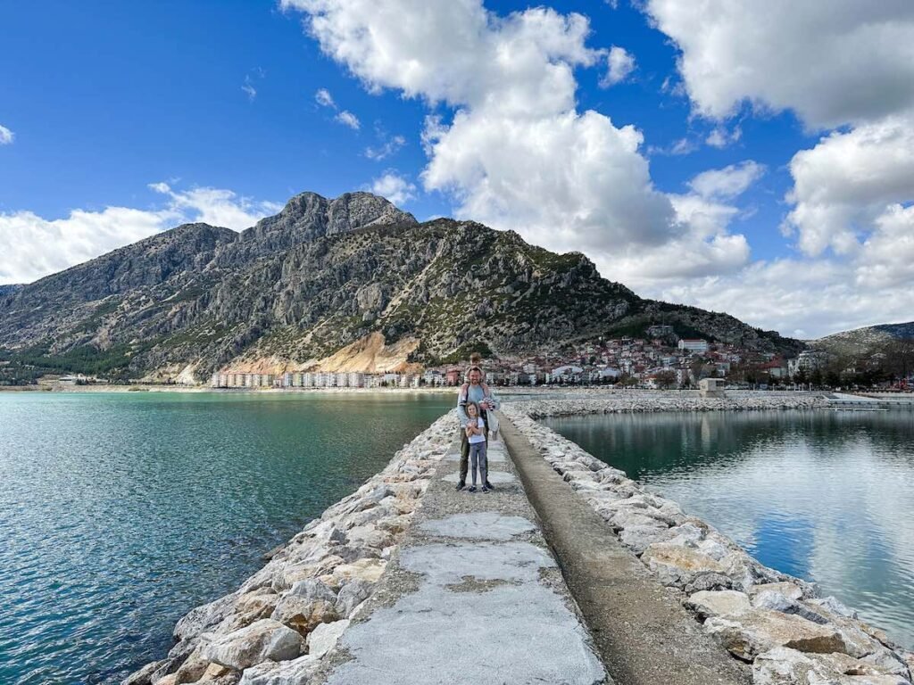 Father and children stand on the pier at Lake Eğirdir Türkiye